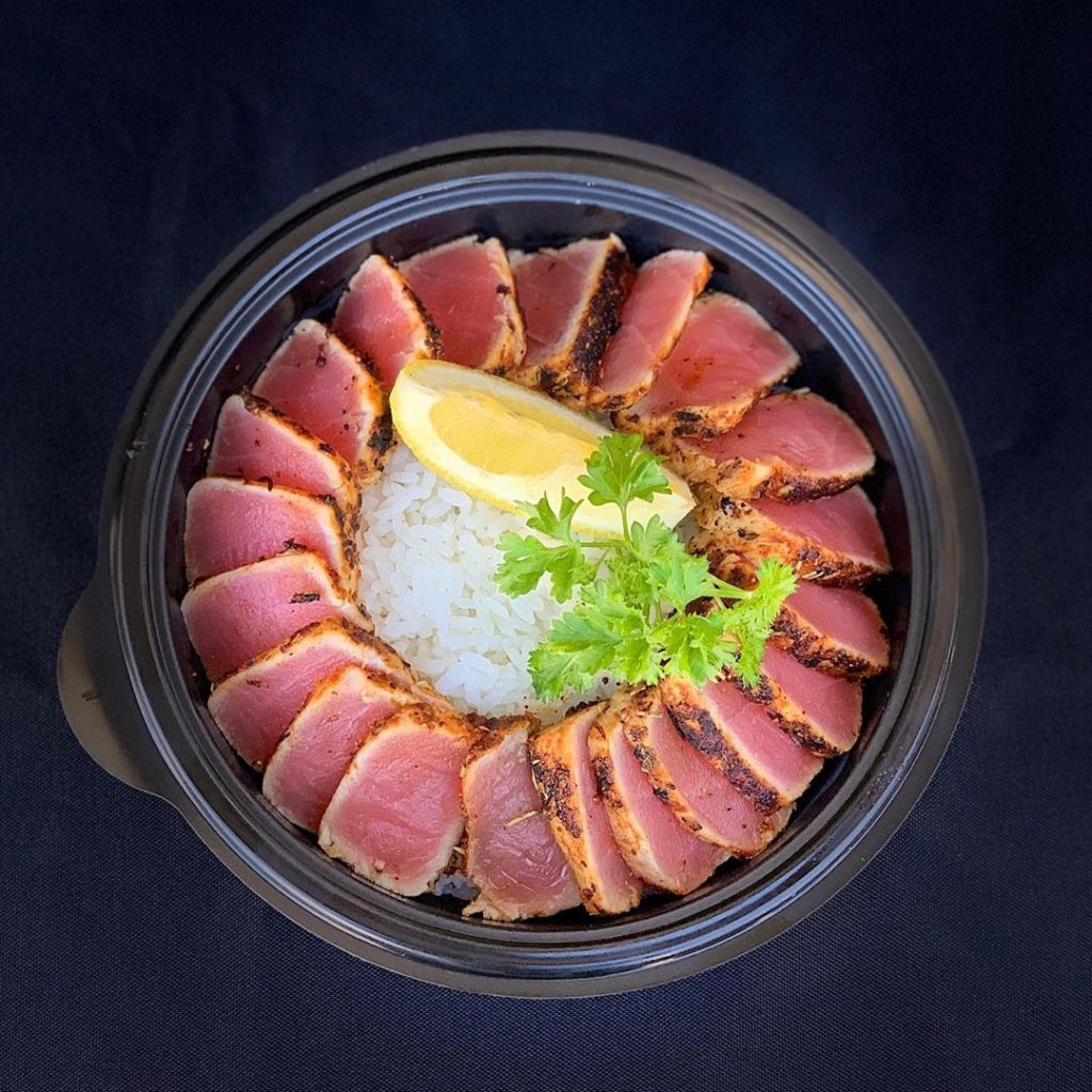 Overhead photo of a takeout bowl with white rice and seared ahi tuna from Tanaka of Tokyo