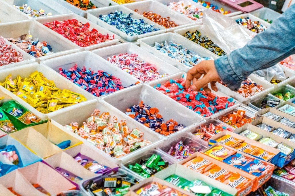 handy picking out candy from a candy store